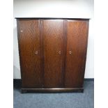 A Stag Minstrel triple door wardrobe in a mahogany finish