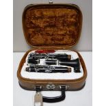 A cased five piece Corton clarinet,