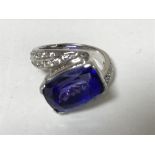 A 14ct gold tanzanite ring set with diamond shoulders, 7.3g, size J.