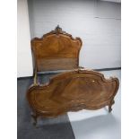 A 4' Louis XV style French walnut bed frame with carved Rococo detail