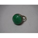 A jade ring set in white metal