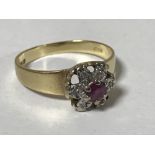 An 18ct gold ruby and diamond cluster ring, size K/L, 2.6g.