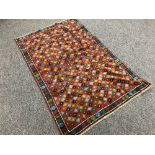 An Eastern carpet with multi colour design 195cm x 127cm
