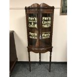 A pair of mahogany glazed bow fronted cabinets on stands ' Fry's Milk Chocolate', height 165 cm.