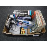 A box containing a Playstation with controller and a small quantity of games,