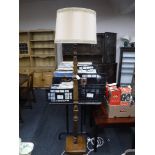 An early 20th century carved oak standard lamp