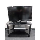 A Sony Bravia 32" LCD TV on stand with remote,