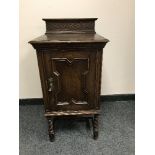 An Edwardian oak bedside cabinet,