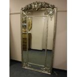 An ornate silvered mirror,