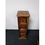 A narrow mango wood four drawer chest