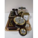 A tray containing two Cumbrian marble mantel clocks, brass carriage clock, two vintage cash boxes,