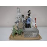 A tray containing Eastern figures, geishas, together with a pottery soldier, boxed Chinese vase,