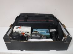 A box of camera bag, camera accessories, Minolta Dynax 600 SI camera, flash lens,