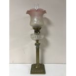 A Victorian glass oil lamp with clear glass reservoir