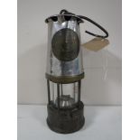 A vintage Protector miner's lamp