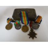 A Princess Mary tin containing five medals including the 1914-15 Star, two Victory Medals,