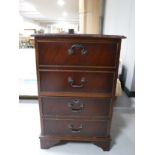 A mahogany two drawer filing chest with brown leather inset panel and inlaid mahogany two tier