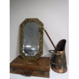 A vintage leather luggage case together with an embossed brass framed mirror,