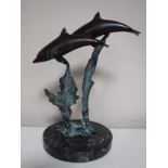 A bronze figure of two dolphins on marble base