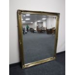 A large ornate gilt framed bevelled overmantel mirror