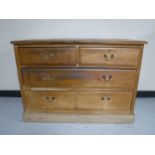 An Edwardian satin walnut four drawer chest