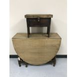 An oak barley twist drop leaf table together with an early twentieth century storage cracket stool