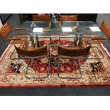 A late 20th century glass top dining table on steel support,