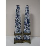 A pair of ormolu mounted blue and white obelisks