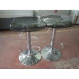 A pair of contemporary gas lift stools