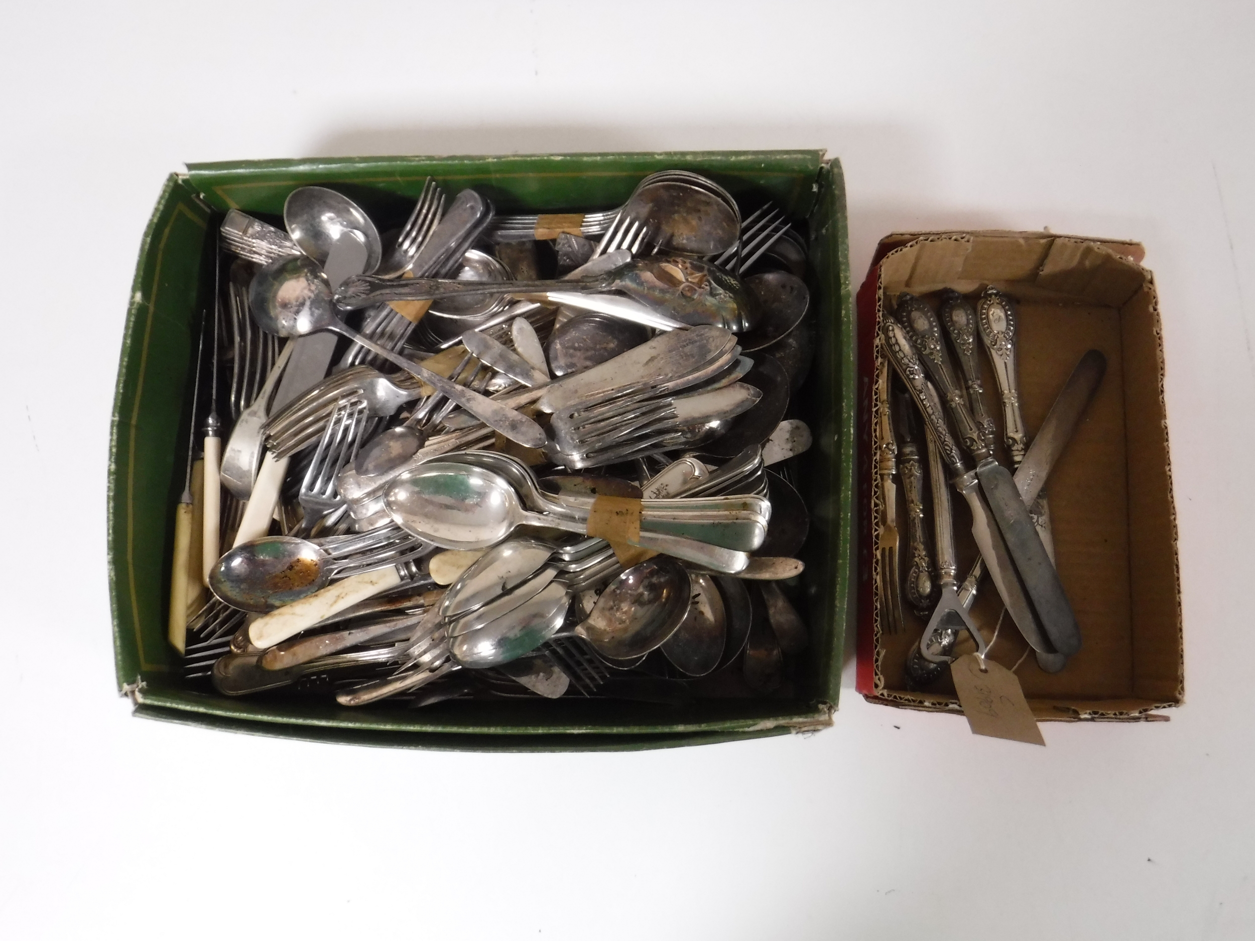 A basket containing cutlery, silver plated knives, forks,