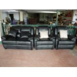 A black leather-look three piece lounge suite with scatter cushions