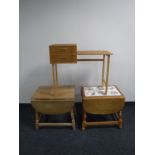 A mid twentieth century Danish teak telephone table together with two blond oak drop leaf tables