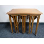 A nest of four twentieth century teak tables