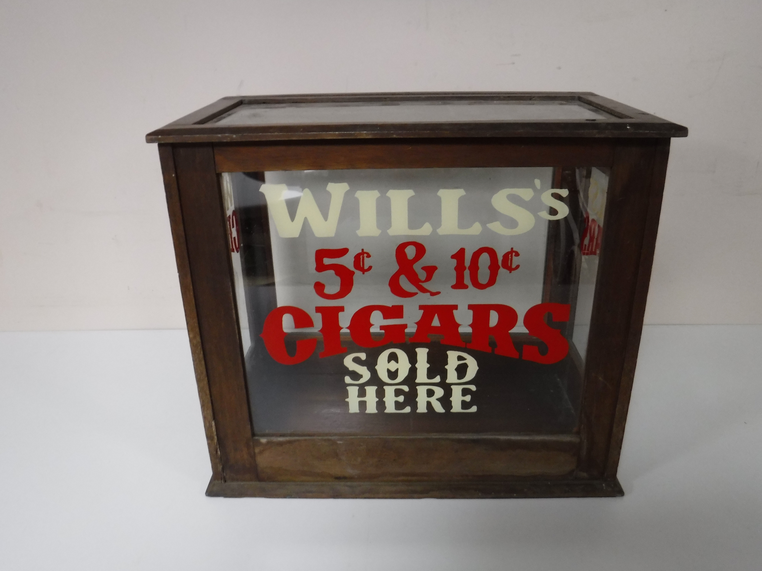 A mahogany counter top display cabinet bearing Wills Cigars advertising