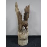 A carved wooden figure of a golden eagle