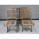 A set of four folding teak garden chairs