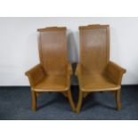 A pair of pitch pine throne armchairs
