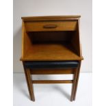 A mid twentieth century teak telephone table