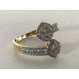 A yellow gold diamond set twist ring, size S.