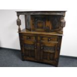 A carved oak buffet backed sideboard