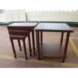 A two tier lamp table and nest of three tables in a mahogany finish
