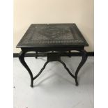 An early twentieth century carved ebonised occasional table