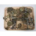 A tray of horse brasses, horse bit, brass horse ornament,