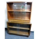 Two sets of mid twentieth century sliding glass door bookshelves