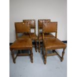 A set of four carved oak buttoned leather dining chairs