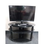 A Toshiba 32 inch lcd tv on stand with remote