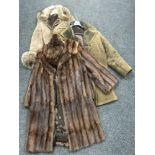 Two sheepskin coats together with a three quarter Coney fur coat