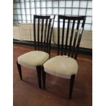 A pair of high gloss high backed dining chairs