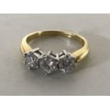 An 18ct gold three stone diamond ring, size K/L,