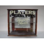 A mahogany counter top display cabinet - Player's cigarettes